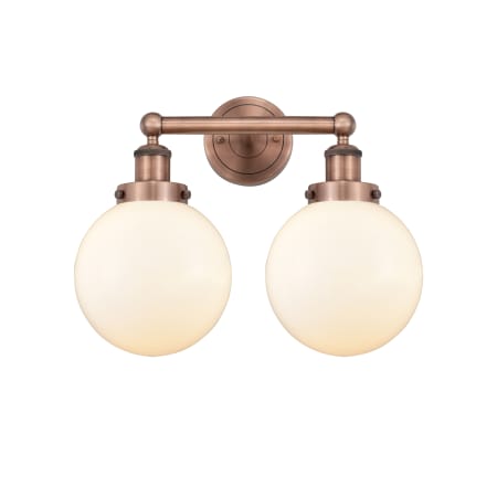 A large image of the Innovations Lighting 616-2W-10-16-L Beacon Vanity Antique Copper / Matte White