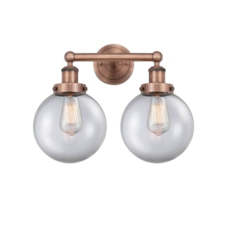 A large image of the Innovations Lighting 616-2W-10-16-L Beacon Vanity Antique Copper / Clear