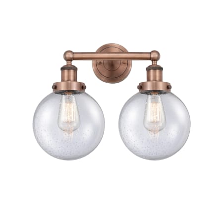 A large image of the Innovations Lighting 616-2W-10-16-L Beacon Vanity Antique Copper / Seedy