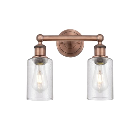 A large image of the Innovations Lighting 616-2W-11-13 Clymer Vanity Antique Copper / Seedy