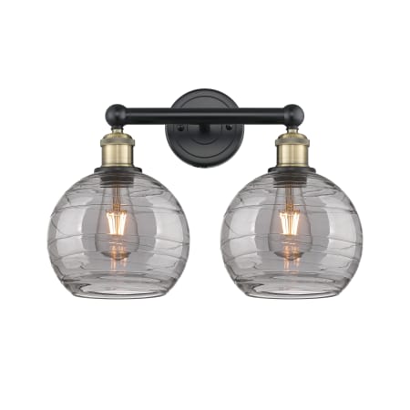 A large image of the Innovations Lighting 616-2W 12 17 Athens Deco Swirl Vanity Black Antique Brass / Light Smoke Deco Swirl