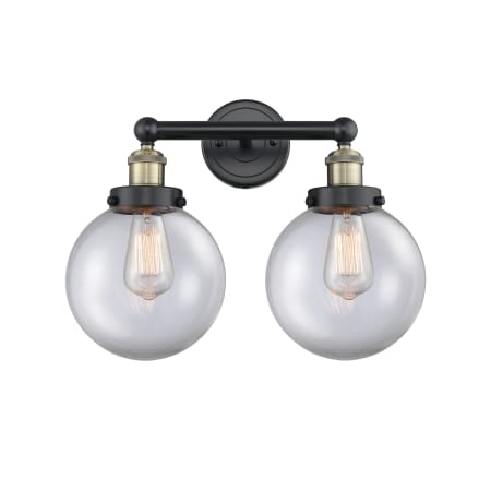 A large image of the Innovations Lighting 616-2W-10-16-L Beacon Vanity Black Antique Brass / Clear