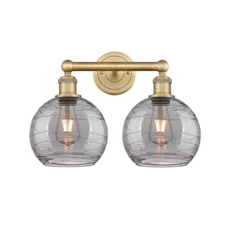 A large image of the Innovations Lighting 616-2W 12 17 Athens Deco Swirl Vanity Brushed Brass / Light Smoke Deco Swirl