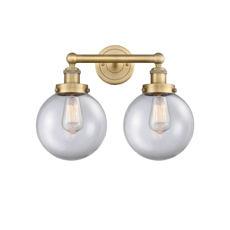 A large image of the Innovations Lighting 616-2W-10-16-L Beacon Vanity Brushed Brass / Clear