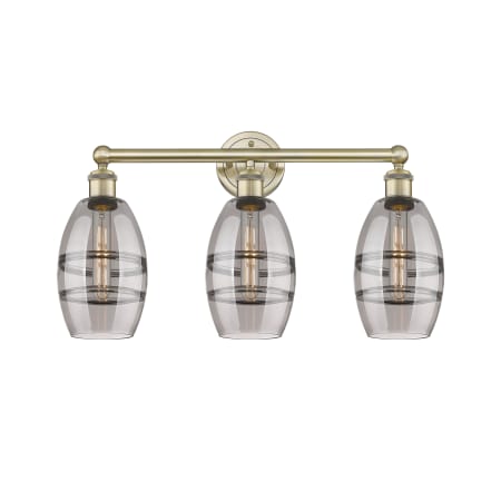 A large image of the Innovations Lighting 616-3W 10 24 Vaz Vanity Antique Brass / Light Smoke