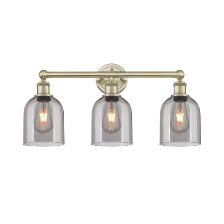 A large image of the Innovations Lighting 616-3W 12 24 Bella Vanity Antique Brass / Light Smoke