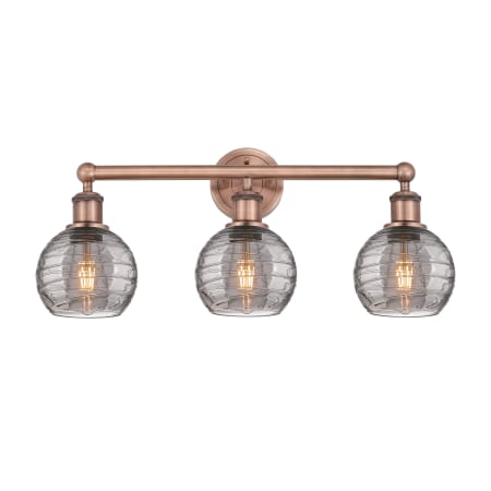 A large image of the Innovations Lighting 616-3W 10 24 Athens Deco Swirl Vanity Antique Copper / Light Smoke Deco Swirl