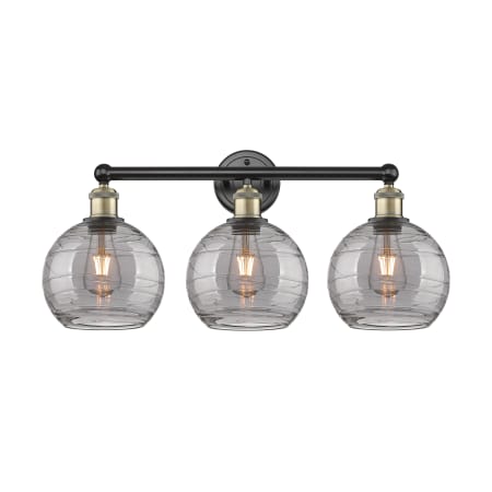 A large image of the Innovations Lighting 616-3W 12 26 Athens Deco Swirl Vanity Black Antique Brass / Light Smoke Deco Swirl