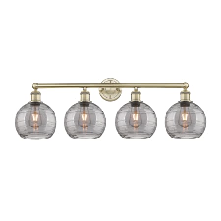 A large image of the Innovations Lighting 616-4W 12 35 Athens Deco Swirl Vanity Antique Brass / Light Smoke Deco Swirl