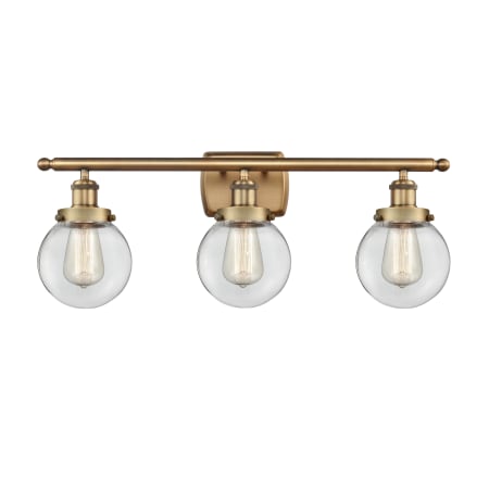 A large image of the Innovations Lighting 916-3W-11-26 Beacon Vanity Brushed Brass / Clear