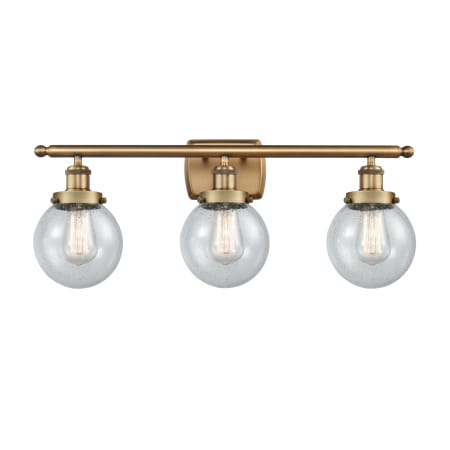 A large image of the Innovations Lighting 916-3W-11-26 Beacon Vanity Brushed Brass / Seedy