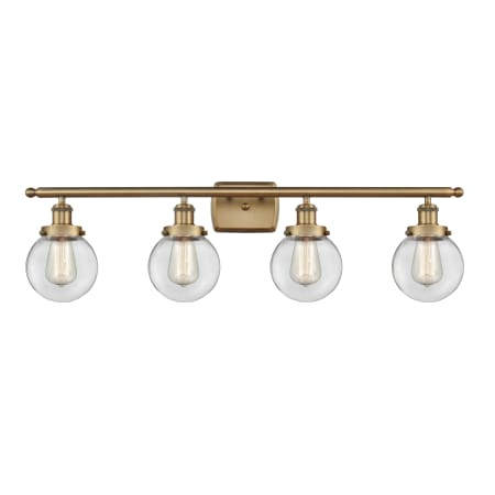 A large image of the Innovations Lighting 916-4W-11-36 Beacon Vanity Brushed Brass / Clear