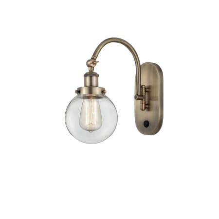 A large image of the Innovations Lighting 918-1W-13-6 Beacon Sconce Antique Brass / Clear