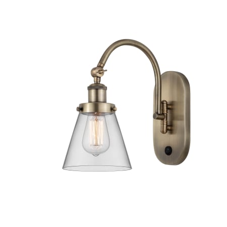 A large image of the Innovations Lighting 918-1W-13-6 Cone Sconce Antique Brass / Clear