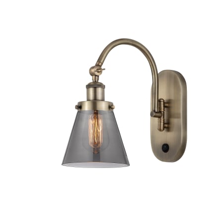 A large image of the Innovations Lighting 918-1W-13-7 Cone Sconce Antique Brass / Plated Smoke