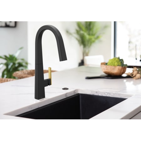 A large image of the Moen S75005 Matte Black Faucet with Brushed Gold Handle