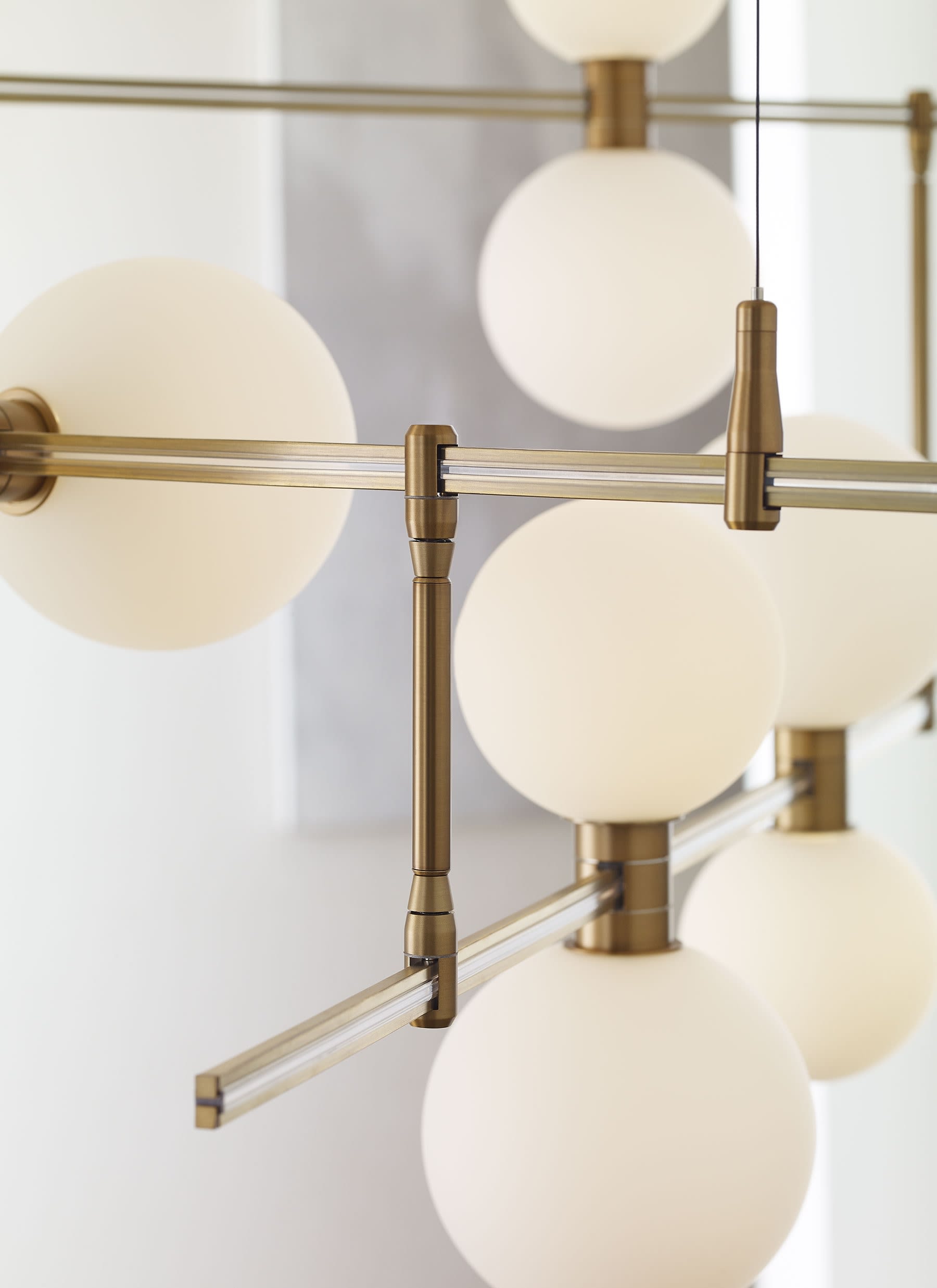 Visual Comfort 700MDCHGRS Aged Brass Glass Orbs ModernRail 48 Wide Integrated LED Linear Chandelier with Surface Transformer and Frosted Orb Shades LightingDirect