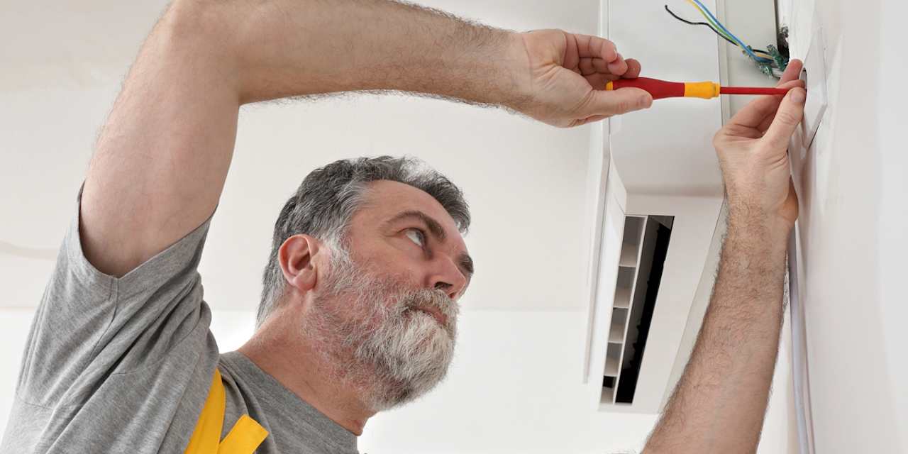 Professional Installer Wiring a Mini-Split Unit