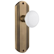 Nostalgic Warehouse Vintage White Porcelain Passage Door Knob Set with Brass Art Deco Plate and 2-3/8" Backset Antique Brass