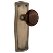 Nostalgic Warehouse Brown Porcelain Solid Brass Passage Door Knob Set with Prairie Rose and 2-3/8" Backset Antique Brass