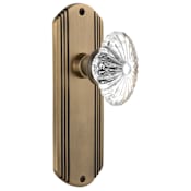 Nostalgic Warehouse Vintage Farmhouse Oval Fluted Crystal Flower Passage Door Knob Set with Art Deco Plate and 2-3/4" Backset Antique Brass