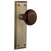 Nostalgic Warehouse Brown Porcelain Solid Brass Passage Door Knob Set with New York Rose and 2-3/8" Backset Antique Brass