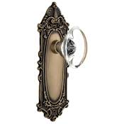 Nostalgic Warehouse Oval Clear Crystal Solid Brass Privacy Door Knob Set with Victorian Rose and 2-3/8" Backset Antique Brass