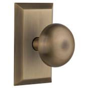 Nostalgic Warehouse New York Solid Brass Passage Door Knob Set with Studio Rose and 2-3/8" Backset Antique Brass