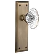Nostalgic Warehouse Oval Fluted Crystal Solid Brass Privacy Door Knob Set with New York Rose and 2-3/4" Backset Antique Brass