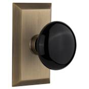 Nostalgic Warehouse Black Porcelain Solid Brass Privacy Door Knob Set with Studio Rose and 2-3/4" Backset Antique Brass