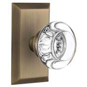 Nostalgic Warehouse Round Clear Crystal Solid Brass Privacy Door Knob Set with Studio Rose and 2-3/4" Backset Antique Brass