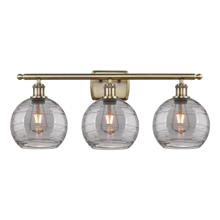 Innovations Lighting Athens Deco Swirl 3 Light 28" Wide Vanity Light Antique Brass / Light Smoke Deco Swirl