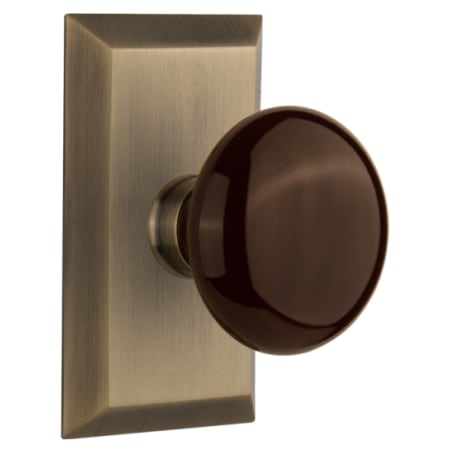 Nostalgic Warehouse Brown Porcelain Solid Brass Passage Door Knob Set with Studio Rose and 2-3/4" Backset Antique Brass