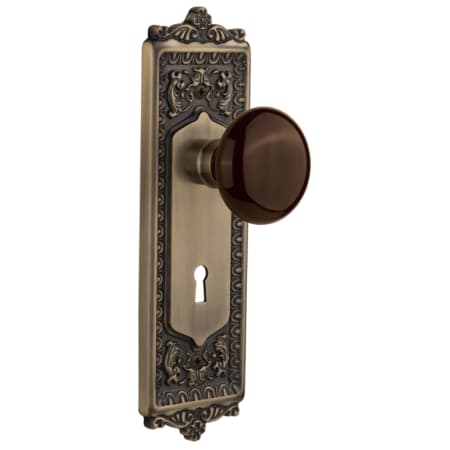Nostalgic Warehouse Brown Porcelain Passage Door Knob Set with Solid Brass Victorian Egg and Dart Back Plate, Keyhole and 2-3/8" Backset Antique Brass