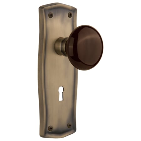 Nostalgic Warehouse Brown Porcelain Solid Brass Privacy Door Knob Set with Prairie Rose, Keyhole and 2-3/8" Backset Antique Brass