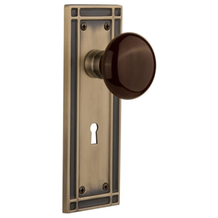 Nostalgic Warehouse Brown Porcelain Solid Brass Passage Door Knob Set with Mission Rose, Keyhole and 2-3/4" Backset Antique Brass