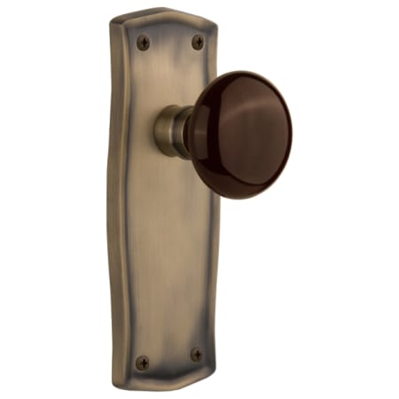 Nostalgic Warehouse Brown Porcelain Solid Brass Privacy Door Knob Set with Prairie Rose and 2-3/4" Backset Antique Brass