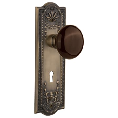 Nostalgic Warehouse Brown Porcelain Solid Brass Privacy Door Knob Set with Meadows Rose, Keyhole and 2-3/4" Backset Antique Brass