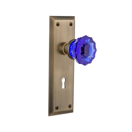 Nostalgic Warehouse New York Solid Brass Rose Privacy Door Knob Set with Cobalt Crystal Knob and Decorative Keyhole for 2-3/8" Backset Antique Brass