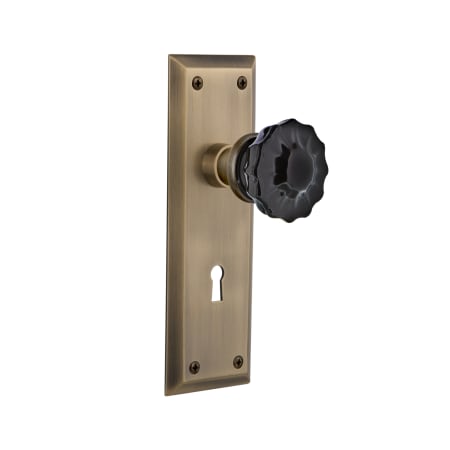 Nostalgic Warehouse New York Solid Brass Rose Privacy Door Knob Set with Black Crystal Knob and Decorative Keyhole for 2-3/4" Backset Antique Brass