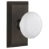 Nostalgic Warehouse White Porcelain Solid Brass Passage Door Knob Set with Studio Rose and 2-3/8" Backset Oil-Rubbed Bronze