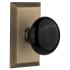 Nostalgic Warehouse Black Porcelain Solid Brass Privacy Door Knob Set with Studio Rose and 2-3/4" Backset Antique Brass