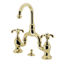 Kingston Brass French Country 1.2 GPM Bridge Bathroom Faucet with Pop-Up Drain Assembly Polished Brass