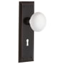 Nostalgic Warehouse White Porcelain Solid Brass Passage Door Knob Set with New York Rose, Keyhole and 2-3/8" Backset Timeless Bronze