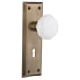 Nostalgic Warehouse White Porcelain Solid Brass Vintage Skeleton Key Retrofit Entry Handleset Trim with New York Rose, Keyhole and 2-1/4" Backset Antique Brass