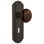 Nostalgic Warehouse Vintage Brown Porcelain Privacy Door Knob Set with Art Deco Plate, Keyhole and 2-3/8" Backset Oil-Rubbed Bronze