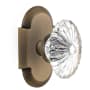 Nostalgic Warehouse Vintage Farmhouse Oval Fluted Crystal Flower Passage Door Knob Set with Solid Brass Cottage Style Plate and 2-3/4" Backset Antique Brass