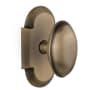 Nostalgic Warehouse Vintage Farmhouse Homestead Oval Solid Brass Passage Door Knob Set with Cottage Style Plate and 2-3/8" Backset Antique Brass
