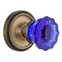 Nostalgic Warehouse Classic Solid Brass Rose Passage Door Knob Set with Cobalt Crystal Knob and 2-3/8" Backset Antique Brass