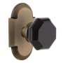 Nostalgic Warehouse Cottage Solid Brass Rose Privacy Door Knob Set with Black Waldorf Knob and 2-3/8" Backset Antique Brass